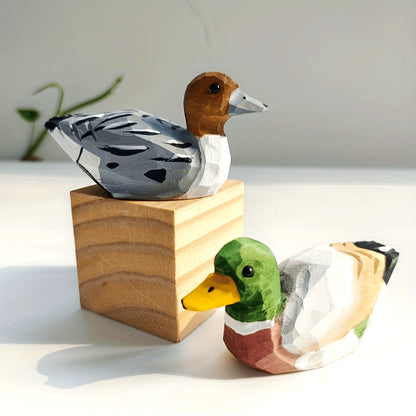 Handcrafted wooden figurines of a green duck – male and female