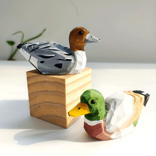 Handcrafted wooden figurines of a green duck – male and female