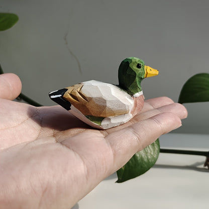 Handcrafted wooden figurines of a green duck – male and female