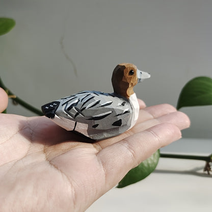 Handcrafted wooden figurines of a green duck – male and female